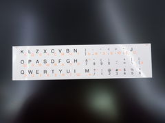 Наклейки на клавиатуру Qwerty-Йцукен оранжевые русские / черные английские буквы на белом фоне. Цвет белый.